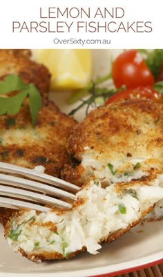 a close up of a plate of food with crab cakes on it and a fork