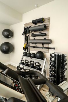 there are many gym equipment in the room with balloons on the wall and other items