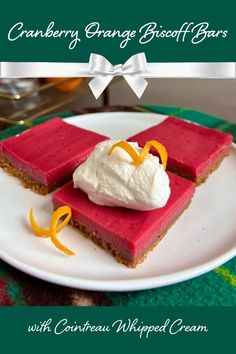 cranberry orange biscuit bars with whipped cream on a white plate and green tablecloth