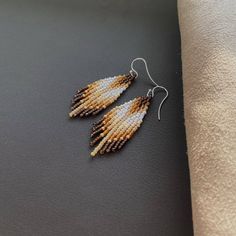 "These fringe beaded earrings in are made of high quality Czech beads. They are lightweight and comfortable. These beaded earrings are an amazing gift for special occasions: holidays, birthdays, anniversaries, Christmas, Valentine's Days and more. It can also be jewelry for the bride or bridesmaids at a boho wedding. This pair is a mix of ethnicity and modern casual style. I create for women who love to feel completely different. Colors: white, beige, gold, brown.  -------------------------------------------- ✦ The Details: ✔ Made with quality Czech beads ✔ Made using strong bead weaving thread.  ✔ Lenght: app. 2 inches ✔ Sterling silver earrings hooks There may be some color discrepancies which is due to the different monitor settings ✦ All  earrings hooks are nickel and lead free! ✦ More Fringe Beaded Earrings, Beautiful Beaded Earring, Colors Brown, Western Jewelry, Autumn Colors, Czech Beads, White Beige, Bead Weaving, How To Make Beads