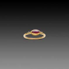 This vibrant rose cut ruby is set in 22k gold bezel and accented with a diamond dot on both points. 1.5 mm 18k hammered band. Ruby measures approximately 4.5 x 9mm. Matte finish. Gold Stackable Rings With Ruby Bezel Setting, Gold Ruby Birthstone Ring With Bezel Setting, Diamond Dots, Hammered Band, Ring With Diamond, Ruby Ring, 22k Gold, Rose Cut, Rose Gold Ring