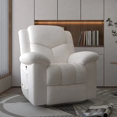 a white recliner chair sitting on top of a rug in a living room next to a book shelf