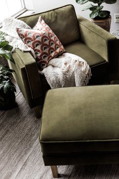 a living room with a green chair and ottoman