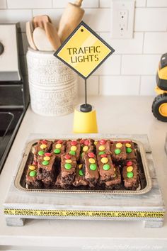 there is a tray of brownies with candy on it and a sign that says traffic lights