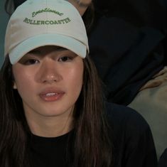 a woman wearing a white hat with the word rollercoaste on it's side