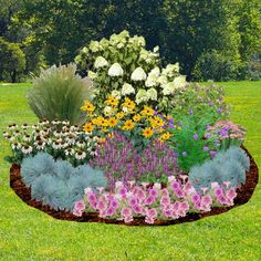 a flower garden in the middle of a field with lots of flowers and plants around it