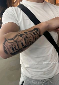 a man with a cross tattoo on his arm