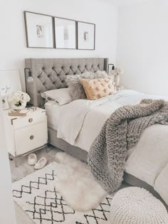 a bedroom with a bed, rugs and pictures on the wall above it is shown