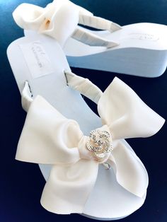 Crystal Love knot Adhered Firmly to a Beautiful Full Ivory Satin Bow. Straps Wrapped Tightly With same Color Ribbon. Rush Orders Welcome.. Click Below Link to Rush your Order. Ships Following Day!! https://www.etsy.com/listing/211630967/rush-order-expedited?ref=shop_home_active_46&frs=1 Ships Internationally! 7 Days a Week Availability Contact Audrey for Questions or Design Changes.. Blush Bridal Shoes, Bridesmaid Shoes Flat, Sandals For Bride, Bridesmaid Flip Flops, Flip Flops Platform, Bridal Wedges, Bridal Flip Flops, White Bridal Shoes, Ivory Bridal Shoes