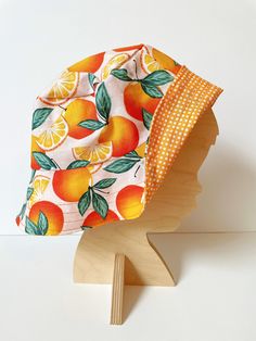 Stay cool this summer with the light-weight, cotton Orange Fruit Bucket Hat! This hat is reversible with an adorable orange polka dot lining.  It's made to order in a variety of sizes, from newborn to adult. Have fun matching the whole family! If you would like an Adult and Kid matching set, there is an option below in variations with a little discount for you! When you check out, please leave the sizes that you would like the hats to be (for example: S/M Adult and M/L Child) in the notes to sellers.  Each hat is hand-sewn with precision and care, hygienically handled in a smoke-free household. Details:  *Lightweight Cotton Fabric *Reversible *Sizes Newborn to Adult  *100% Handmade!  Follow along our handmade bow adventures on Instagram and Facebook at IrisandMae Thank you for support our Fruit Bucket Hat, Fruit Bucket, Retro Fruit, Orange Citrus, Reversible Bucket Hat, Orange Fruit, Handmade Bows, Sun Hats