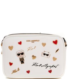 From KARL LAGERFELD PARIS&#x2C; The Embellished Maybelle Camera Crossbody Bag features:Polyvinyl chlorideNylon liningDouble top zipper closure1 Back slip pocket1 Slip pocket&#x2C; 3 card slitsAdjustable crossbody strapApprox. 9" W x 6" H x 3" D; 14" - 23" strap dropImported. White Travel Bag With Logo Hardware, White Rectangular Bag With Metal Logo, Designer White Bag With Embroidered Logo, Luxury White Bags With Metal Logo, White Crossbody Shoulder Bag With Logo Hardware, White Crossbody Shoulder Bag With Metal Logo, Karl Lagerfeld Bag, Karl Lagerfeld Purse, Karl Lagerfeld Bags