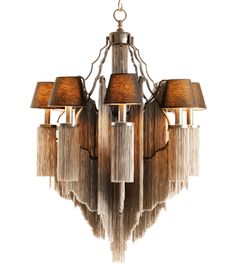 a chandelier with five lamps hanging from it's sides and fringed shades