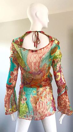 For Sale on 1stDibs - Stunning Vintage 1990s MAURIZIA BYOUX colorful mixed patterned silk chiffon Italian tunic blouse! Features beadwork along the neckline. Bell sleeves have Multicolor Sheer Party Tops, Summer Fitted Silk Chiffon Blouse, Multicolor Sheer Top For Party, Multicolor Sheer Tops For Party, Fitted Silk Chiffon Blouse For Summer, Fitted Multicolor Blouse For Festival, Bohemian Multicolor Silk Blouse, Colorful Fitted Bohemian Tops, Bohemian Multicolor Silk Tops