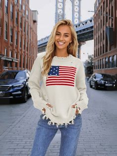 Stand out in style with our American Flag Relaxed Knit Sweater! This quirky and fun sweater features the iconic stars and stripes design, adding a playful touch to your look. Stay comfortable and show off your patriotic side with this cozy and unique sweater. Size Guide: Model is 5’7” tall, and has a 32.7” bust, 24.6”waist, & 36.2” hips. She is wearing a S / US 4 / AU 8. This sweater is true to size. Feature: Ripped crew neckline. Long sleeves. Ripped knit fabrication details. Not lined. Oversized Relaxed Fit. Material: 100% Acrylic. Care Instructions: Machine wash / Cold hand wash. Casual Crew Neck Sweater With Star Print, Knit Sweater With Star Print Long Sleeve, Casual Fall Sweater With Star Print, Fall Flag Print Long Sleeve Sweater, Long Sleeve Flag Print Sweater For Fall, Fall Long Sleeve Flag Print Sweater, Long Sleeve Tops For 4th Of July, Spring Americana Long Sleeve Tops, Americana Style Cotton Tops For Fall