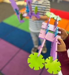 two children are playing with toys on the floor