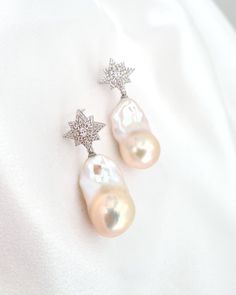 "Elevate your style with our Large White Baroque Pearl Starburst Earrings. These exquisite earrings combine the captivating beauty of baroque pearls with a dazzling starburst design. The lustrous pearls take center stage, radiating elegance and charm. Whether it's a special occasion or a fashionable statement, these earrings will adorn you with timeless grace. ♡ ♡ The baroque pearls depicted in the pictures serve as a representation of what you will receive. Please keep in mind that each and eve Elegant Star-shaped Pearl Earrings, Elegant Star-shaped Pearl Drop Earrings, Elegant White Star-shaped Pearl Earrings, White Star-shaped Earrings For Wedding, White Star-shaped Wedding Earrings, Big Pearl Jewelry, Statement Pearl Earrings, Pearl Statement Earrings, Starburst Design