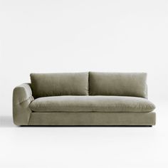 a beige couch sitting on top of a white floor