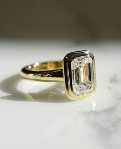 a close up of a ring with a diamond on it's center and side