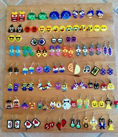 a wooden board with many different earrings on it, all decorated in pixel art style