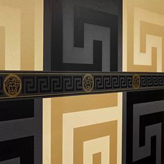 a black and gold wall with different designs on it