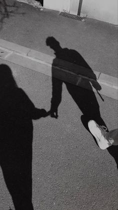 the shadow of a person standing next to a skateboard