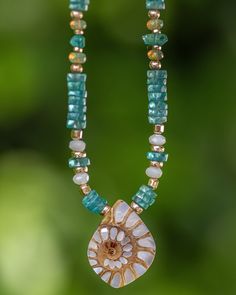 This stunning mother of pearl inlay shell necklace is truly one of a kind. This ammonite shell is inlaid with gorgeous mother of pearl for a piece you will find no where else since each shell is unique. It is paired with bright aqua blue apatite to bring in those Caribbean feels. There are accents in mother of pearl as well as fiery Ethiopian opals. It is truly a stunning piece that is elegant without being over the top. The perfect necklace for your summer escapades! Please note: Ethiopian opals are water absorbent. Please keep these away from water or excessive sweat. Do not shower, bathe, workout, or swim with these in order to keep these gems looking their fiery best. Your gems will thank you. Details: Mother of Pearl Ammonite Shell, Apatite, Ethiopian Opals, Mother of Pearl 14/20 Gold Ammonite Shell, Mother Of Pearl Inlay, Pearl Inlay, Gold Gemstone Ring, Blue Apatite, Shell Necklace, Shell Necklaces, 14kt Gold, Ethiopian Opal