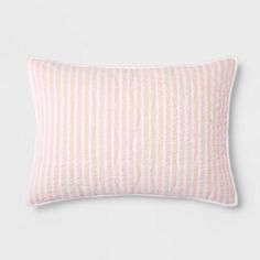 a pink and white striped pillow on a white background