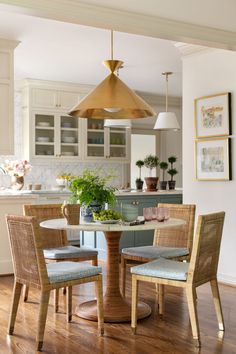 a kitchen table with four chairs around it