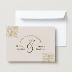 a wedding card with gold foiling on the front and back, featuring an elegant floral design