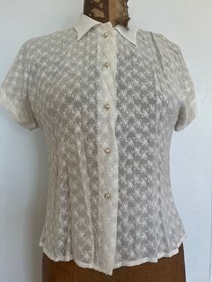 Fun white sheer blouse; five pearl shaped buttons, adorned with a sparkle centre. Short sleeves  Armpit to armpit 17" Sleeve to sleeve 24" Neck to hem 20" Good vintage condition; age related discolouration SHOP THE STORE:  https://www.etsy.com/shop/BrocanteBedStuy Classic Sheer Top For Formal Occasions, Classic Sheer Tops For Formal Occasions, Classic Sheer Button-up Blouse, Classic Formal Blouse With Pearl Buttons, Fitted Button-up Blouse With Pearl Buttons, Classic Fitted Blouse With Pearl Buttons, White Sheer Tops For Formal Occasions, Formal Fitted Tops With Pearl Buttons, Formal Sheer White Top