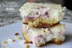 two pieces of strawberry cheesecake bars stacked on top of each other