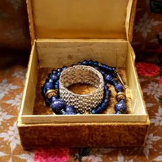 an open box with bracelets and other items in it