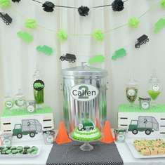 a table topped with cakes and desserts covered in green frosting