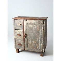 an old wooden cabinet with two drawers on one side and rusted paint on the other