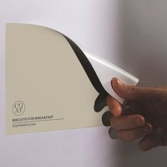 a person is holding up a piece of paper