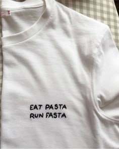 a white t - shirt with the words eat pasta run fast on it's chest