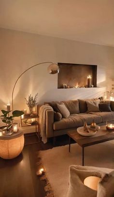 a living room filled with lots of furniture and candles on the wall next to it