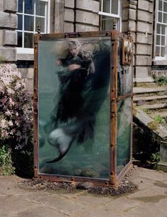 a large metal box with an image of a woman swimming in the water on it