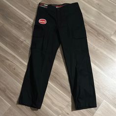 Never Been Worn, Black, Great Condition Black Straight Leg Work Pants With Pockets, Black Work Pants With Side Pockets, Black Tapered Leg Cargo Work Pants, Black Tapered Leg Work Pants With Cargo Pockets, Black Full Length Work Pants With Side Pockets, Black Straight Leg Work Pants With Cargo Pockets, Black Work Pants With Cargo Pockets, Fitted Black Work Pants With Pockets, Black Tapered Leg Work Pants With Pockets