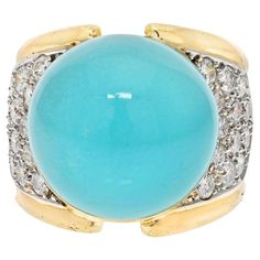 Residing on the coastline infuses an affinity for the ocean's captivating palette. The various shades of blue harmonize effortlessly, and it's in this coastal essence that turquoise jewelry alongside gold emerges as a cherished accessory. Delve into the allure of the stunning David Webb Turquoise and Diamond Ring, a remarkable embodiment of this coastal inspiration. Crafted in the opulent embrace of 18K yellow gold, this statement ring captures attention with its intricate design. The turquoise gem takes center stage, radiating a soothing smoothness that mirrors the tranquil ocean hues. The remarkable condition of this gem stands testament to its enduring beauty. Amplifying the elegance, pave-set diamonds in platinum encircle the turquoise, creating a mesmerizing contrast that elevates the Luxury Turquoise Jewelry With Center Stone, Luxury Turquoise Cabochon Ring In Yellow Gold, Luxury Yellow Gold Turquoise Cabochon Ring, Luxury Turquoise Round Ring, Luxury Yellow Gold Turquoise Ring For Formal Occasions, Elegant Multi-stone Turquoise Ring, Elegant Turquoise Cabochon Gemstones, Luxury Turquoise Cabochon Ring, Luxury Yellow Gold Turquoise Ring With Gemstone Accents