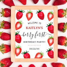 strawberries are arranged around a wooden frame with the words welcome to kathy's berry first birthday party