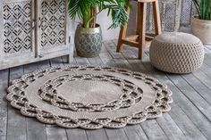 a round rug on the floor next to a potted plant