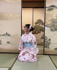 a woman in a kimono sitting on the floor