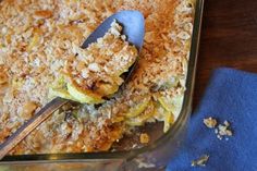 a casserole dish with an oatmeal topping and a spoon in it