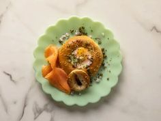 a green plate topped with food on top of a marble counter