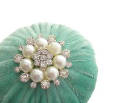 a green hat with pearls on it