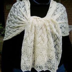 a woman wearing a white knitted shawl