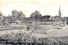 an old black and white photo of people playing in a pond