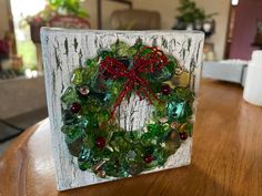 a christmas wreath made out of glass beads