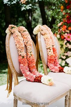 two chairs decorated with flowers and ribbons